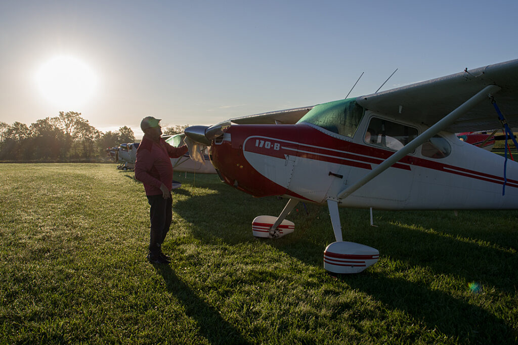 Bill Weyers up early to clean the dew off his 1952 Cessna 170B.